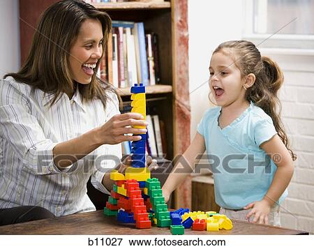 Mother and young daughter playing with building blocks View Large Photo Image Stock Photo - Mother and young daughter playing with building blocks. Fotosearch
