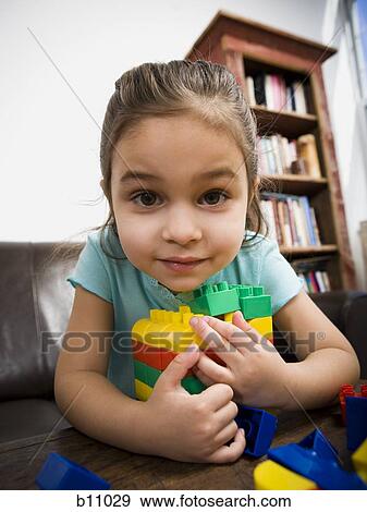 Stock Photo - Mother and young daughter playing with building blocks. Fotosearch