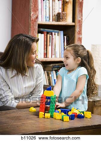 Mother and young daughter playing with building blocks View Large Photo Image Stock Photograph - Mother and young daughter playing with building blocks. Fotosearch