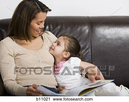 Stock Image - Mother and young daughter snuggling. Fotosearch