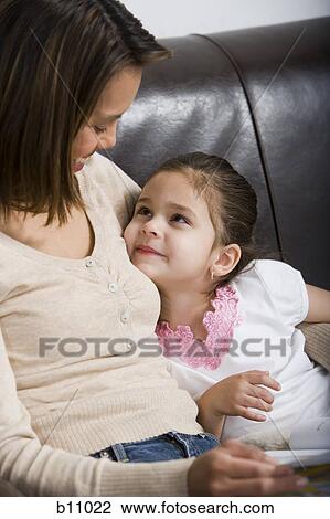 Mother and young daughter snuggling View Large Photo Image Stock Image - Mother and young daughter snuggling. Fotosearch