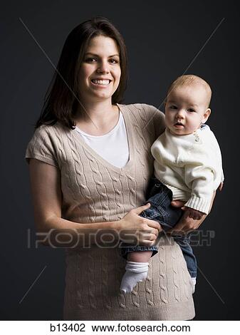 Stock Image - Mother holding baby boy. Fotosearch