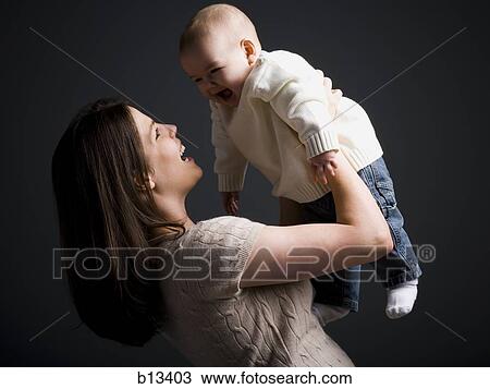 Stock Image - Mother holding baby boy. Fotosearch