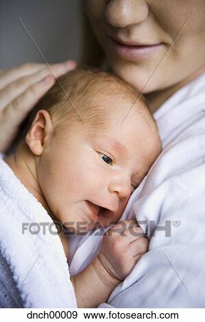 Mother holding newborn View Large Photo Image Stock Photo - Mother holding newborn. Fotosearch