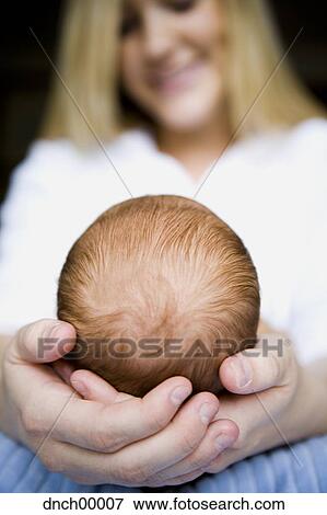 Mother holding newborn's head View Large Photo Image Stock Photo - Mother holding newborn's head. Fotosearch