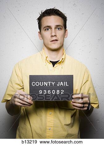 Stock Photo - Mug shot of casually dressed man sneering. Fotosearch