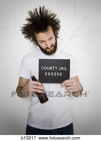 Stock Photo - Mug shot of man with cigarette and beer bottle. Fotosearch