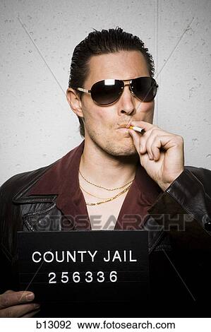Mug shot of man with cigarette and sunglasses View Large Photo Image Stock Image - Mug shot of man with cigarette and sunglasses. Fotosearch