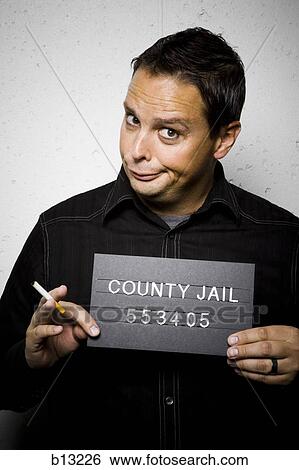 Stock Photograph - Mug shot of man with cigarette. Fotosearch