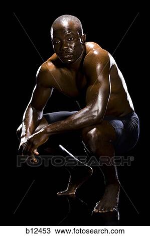 Muscular athlete in dark room View Large Photo Image Stock Image - Muscular athlete in dark room. Fotosearch