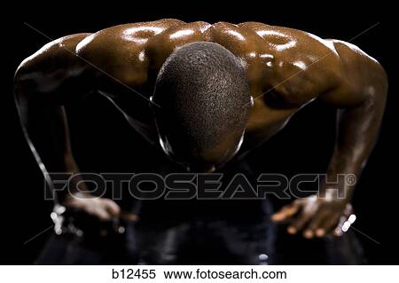 Muscular athlete in dark room View Large Photo Image Stock Photography - Muscular athlete in dark room. Fotosearch