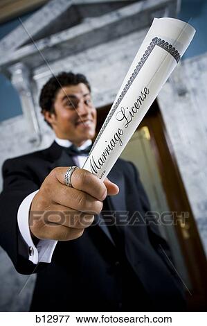 New groom waving wedding license View Large Photo Image Stock Photo - New groom waving wedding license. Fotosearch