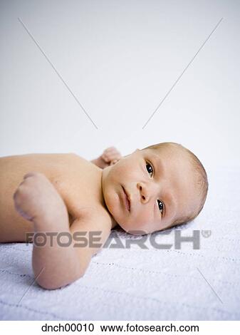 Newborn baby lying down View Large Photo Image Stock Image - Newborn baby lying down. Fotosearch