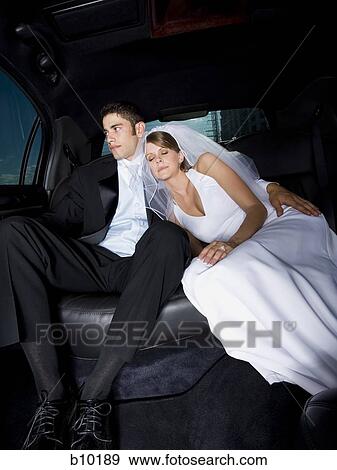 Stock Photo - Newlywed couple sitting in a car. Fotosearch