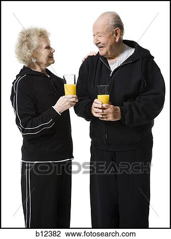 Older couple in track suits taking a juice break View Large Photo Image Stock Image - Older couple in track suits taking a juice break. Fotosearch