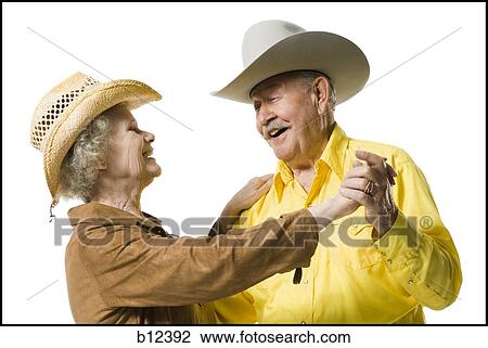 Stock Image - Older couple in western clothing dancing. Fotosearch