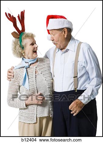 Older couple wearing Christmas hats View Large Photo Image Picture - Older couple wearing Christmas hats. Fotosearch