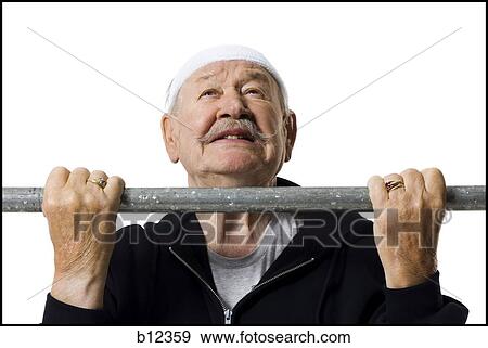 Older man doing chin up exercises View Large Photo Image Stock Photo - Older man doing chin up exercises. Fotosearch