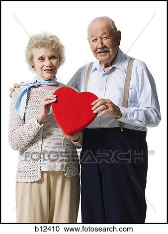 Older man giving wife Valentines chocolate View Large Photo Image Stock Image - Older man giving wife Valentines chocolate. Fotosearch