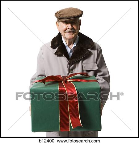 Stock Image - Older man holding present. Fotosearch