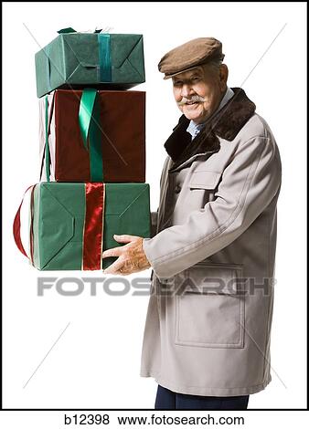 Older man holding presents View Large Photo Image Stock Photo - Older man holding presents. Fotosearch