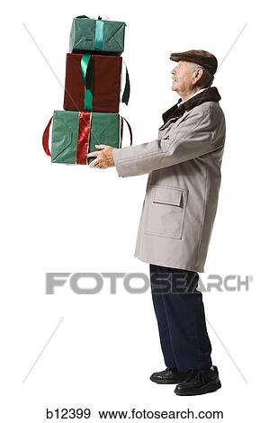 Older man holding presents View Large Photo Image Stock Photo - Older man holding presents. Fotosearch
