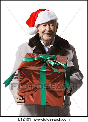 Older man in Santa hat holding a Christmas present View Large Photo Image Stock Image - Older man in Santa hat holding a Christmas present. Fotosearch