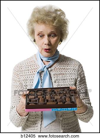 Stock Photography - Older woman holding a box of chocolates. Fotosearch