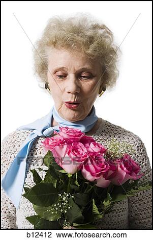 Older woman with a bouquet of pink roses View Large Photo Image Stock Image - Older woman with a bouquet of pink roses. Fotosearch