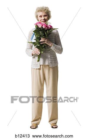 Older woman with a bouquet of pink roses View Large Photo Image Stock Image - Older woman with a bouquet of pink roses. Fotosearch