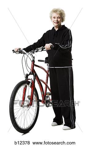 Stock Photo - Older woman with a tandem bicycle. Fotosearch
