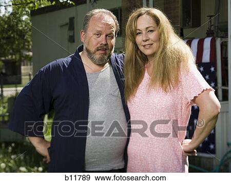 Stock Photo - Overweight couple in a trailer park. Fotosearch