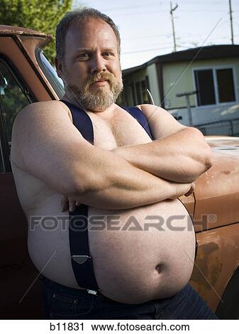 Overweight man with suspenders by truck View Large Photo Image Stock Image - Overweight man with suspenders by truck. Fotosearch
