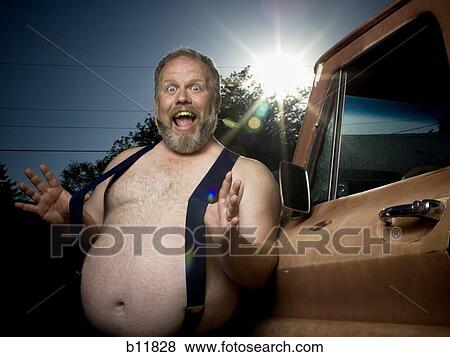Overweight man with suspenders by truck View Large Photo Image Stock Photo - Overweight man with suspenders by truck. Fotosearch