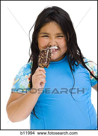 Overweight young girl eating ice cream bar View Large Photo Image Picture - Overweight young girl eating ice cream bar. Fotosearch