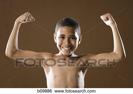 Portrait of a boy flexing his muscles View Large Photo Image Stock Photograph - Portrait of a boy flexing his muscles. Fotosearch