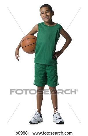 Portrait of a boy holding a basketball View Large Photo Image Stock Image - Portrait of a boy holding a basketball. Fotosearch
