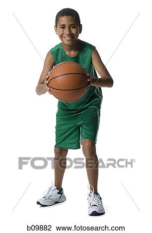 Stock Image - Portrait of a boy holding a basketball. Fotosearch