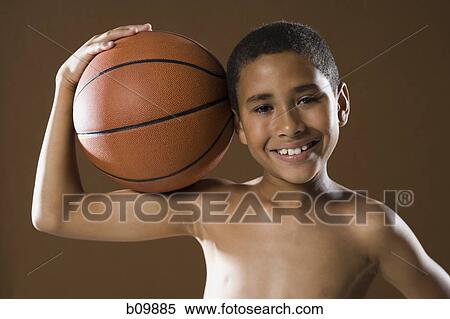Portrait of a boy holding a basketball View Large Photo Image Stock Photography - Portrait of a boy holding a basketball. Fotosearch