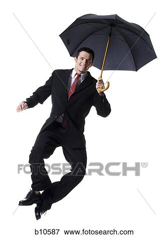 Portrait of a businessman holding an umbrella and jumping View Large Photo Image Stock Photo - Portrait of a businessman holding an umbrella and jumping. Fotosearch