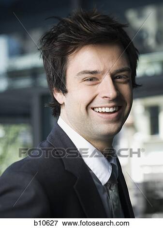Portrait of a businessman smiling View Large Photo Image Stock Photo - Portrait of a businessman smiling. Fotosearch