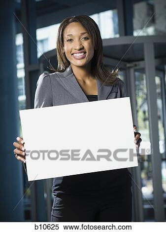 Portrait of a businesswoman holding a blank sign View Large Photo Image Stock Photography - Portrait of a businesswoman holding a blank sign. Fotosearch