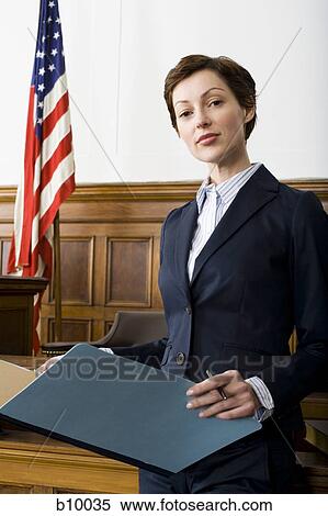 Portrait of a female lawyer standing in a courtroom View Large Photo Image Stock Photography - Portrait of a female lawyer standing in a courtroom. Fotosearch