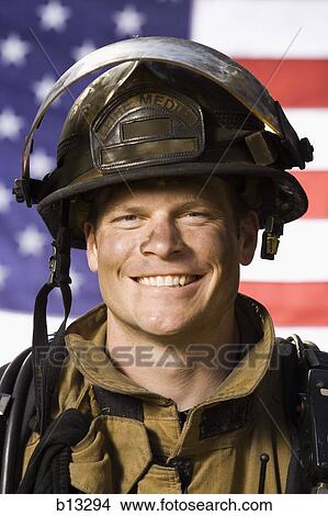Portrait of a firefighter smiling with US flag View Large Photo Image Picture - Portrait of a firefighter smiling with US flag. Fotosearch