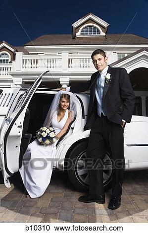 Portrait of a groom standing with a bride sitting in a car View Large Photo Image Stock Image - Portrait of a groom standing with a bride sitting in a car. Fotosearch
