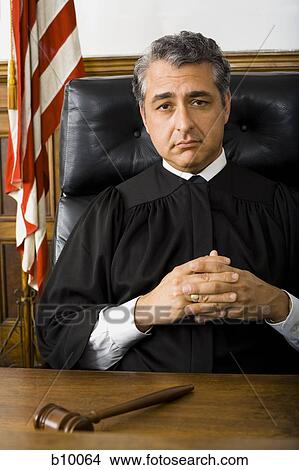 Portrait of a male judge sitting with his hands clasped View Large Photo Image Picture - Portrait of a male judge sitting with his hands clasped. Fotosearch