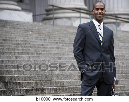 Portrait of a male lawyer standing on the steps of a courthouse and smiling View Large Photo Image Stock Image - Portrait of a male lawyer standing on the steps of a courthouse and smiling. Fotosearch