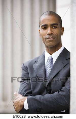 Portrait of a male lawyer standing with his arms folded View Large Photo Image Stock Image - Portrait of a male lawyer standing with his arms folded. Fotosearch