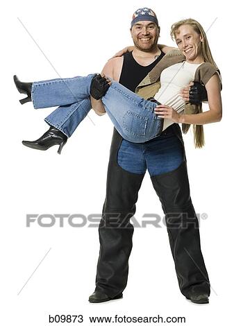 Portrait of a man carrying a young woman View Large Photo Image Stock Image - Portrait of a man carrying a young woman. Fotosearch