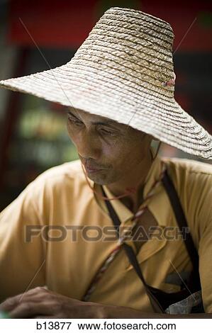 Portrait of a man in sunhat View Large Photo Image Stock Photo - Portrait of a man in sunhat. Fotosearch